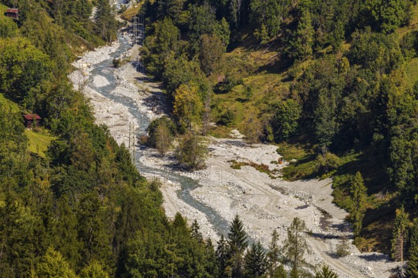 Power lines in the gravel bed of the Navisence stream, Val d'Anniviers, Valais Alps, Canton of