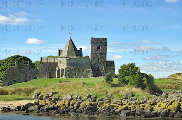 A historic castle on a green field with trees under a blue sky, Inchholm Abbey, Middle Ages, Firth