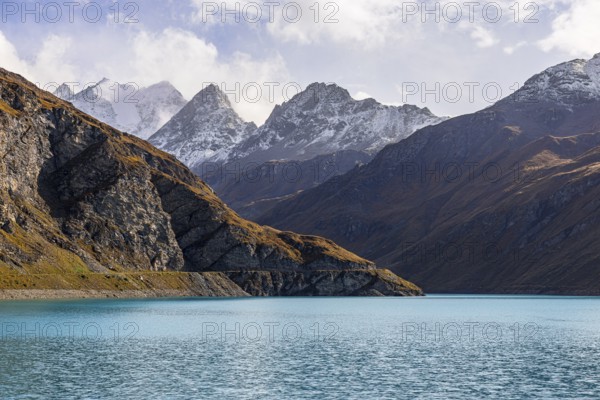 The turquoise Lac de Moiry reservoir, behind the peaks of the Grand Cornier, Tete Blanche and