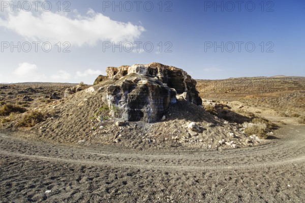 An abandoned quarry with rock formations under a sky with scattered clouds, Los Roferos (Stratified