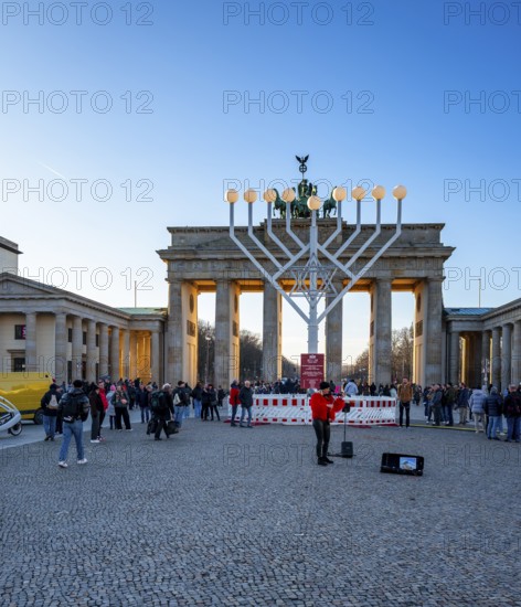 Large Hanukkah chandelier at the Brandenburg Gate in daylight, sign of lively Jewish life, symbolic