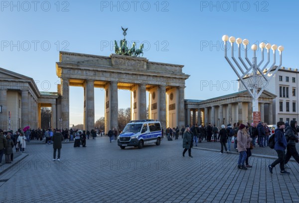 Large Hanukkah chandelier at the Brandenburg Gate in daylight, sign of lively Jewish life, symbolic