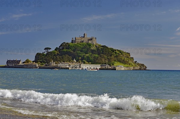 A castle on a hill overlooks the sea with gentle waves, Saint Michael's Mount, Pencanze, Cornwall,