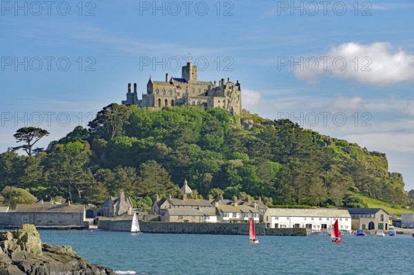 A majestic castle perched on a green hill in front of the sea, Penzance, Saint Michael's Mount,