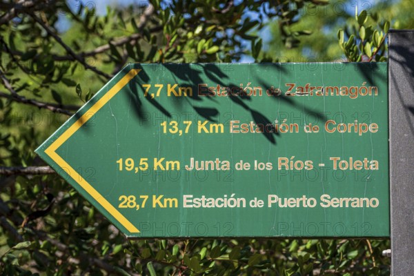 Signpost showing distances along cycle path Via Verde de la Sierra, Puerto Serrano to Olvera, old