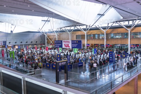 Crowds of international passengers navigating immigration control at pierre elliott trudeau