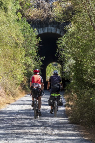 Couple riding bicycle, cycle path Via Verde de la Sierra, Puerto Serrano to Olvera, old railroad