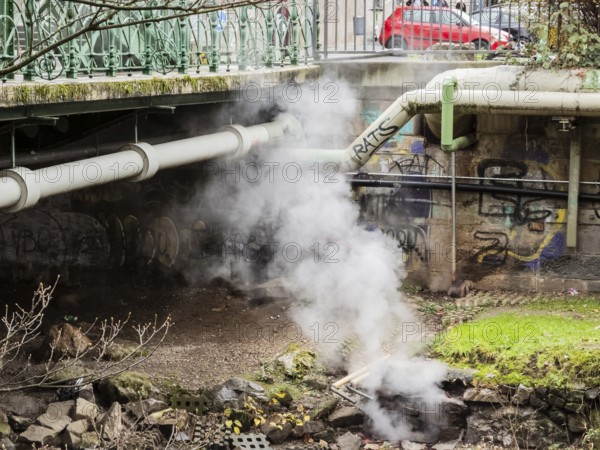 District heating pipeline over the Wupper river, steam escapes, Wuppertal, Germany