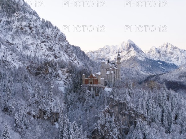 Neuschwanstein Castle rises in a snow-covered mountain landscape with romantic flair, Schwangau