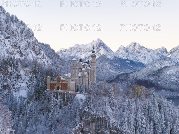 Neuschwanstein Castle rises majestically in a snowy alpine landscape, Schwangau near Füssen,
