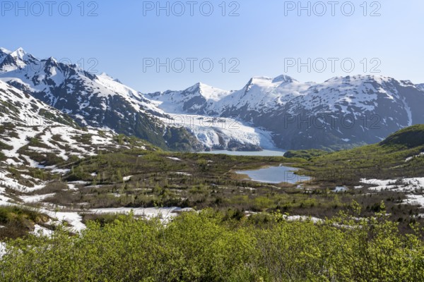 View from Portage Pass of Divide Lake, snowy mountain peaks and glaciers Portage Glacier, Portage