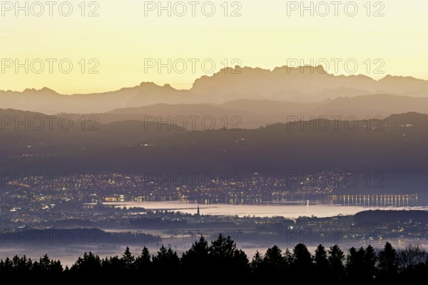 View from Horben of Lake Zug with the town of Cham and Zug, behind it the snow-capped mountains