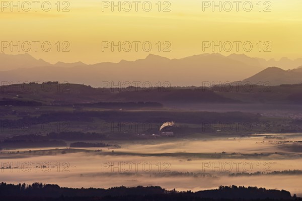 View from Horben of the Reuss Valley covered in fog, behind it the Glarus Alps in the light of the