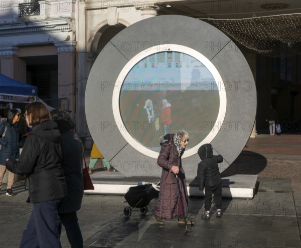 People on the Cornhill in the town centre view the first ever UK Portal in Ipswich, Suffolk,