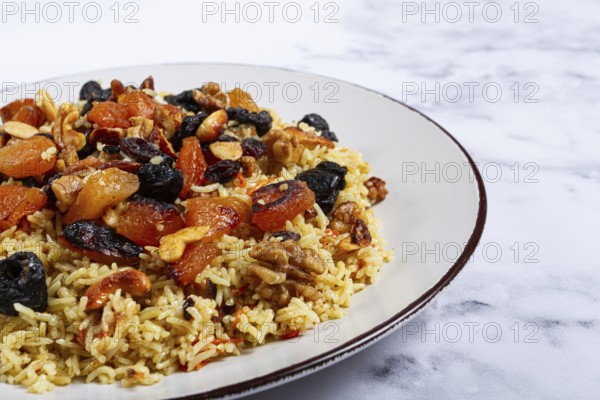 Rice dish, with the addition of dried fruits, nuts and spices of Middle Eastern cuisine, homemade,