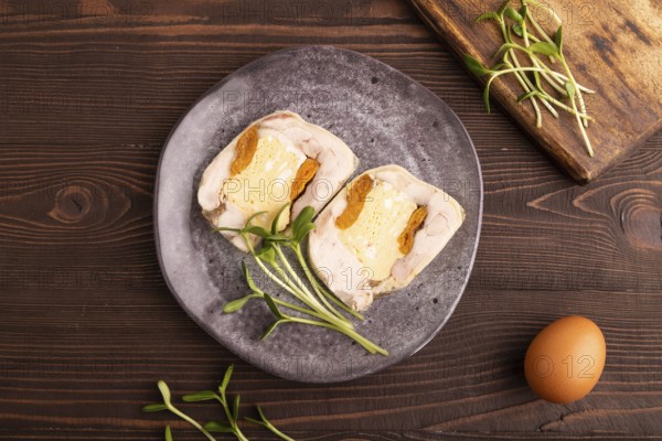 Chicken, egg and dried apricot meatloaf, microgreen on brown wooden. Diet, healthy eating. top