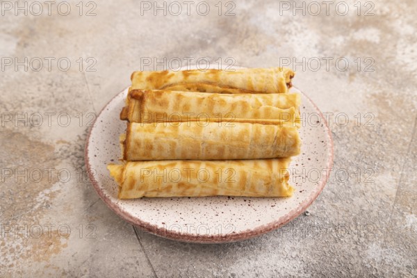 Waffles with caramel on brown concrete background, side view, close up