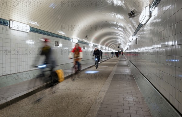 Interior view, pedestrians and cyclists crossing tunnel, mopping effect, movement, tube, historic
