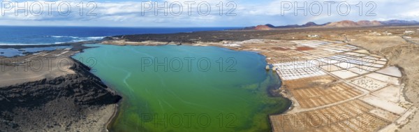 Salt mining plant, Salinas de Janubio with green Laguna de Janubio, near Yaiza, aerial view,