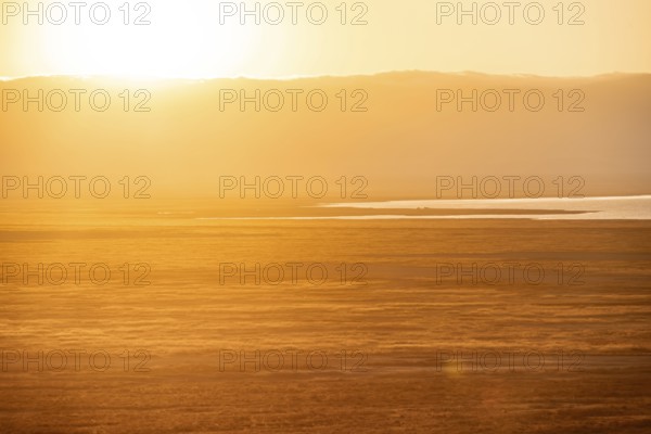 View of savanna landscape at sunrise, atmospheric morning light, view of Ngorongoro Crater, back