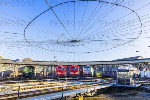 Turntable and overhead line spider, behind it modern locomotives of the Austrian Federal Railways,