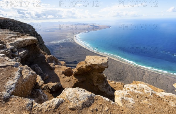 View from the Risco de Famara Cliff to Famara Beach, Playa de Famara with La Calaeta, Lanzarote,