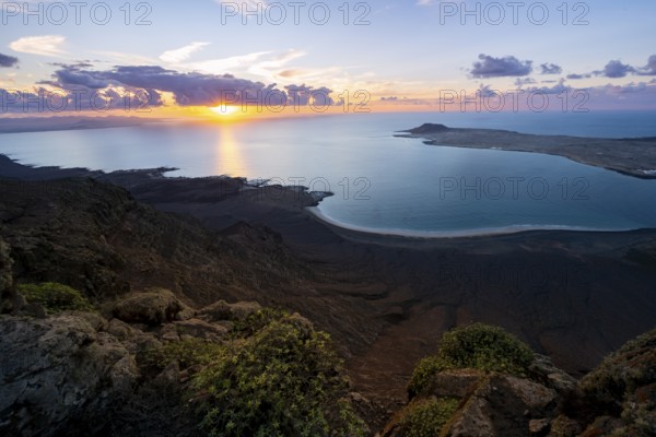 View from steep cliffs to sea and coast with sun stars, Mirador del Porrito viewpoint at sunset,