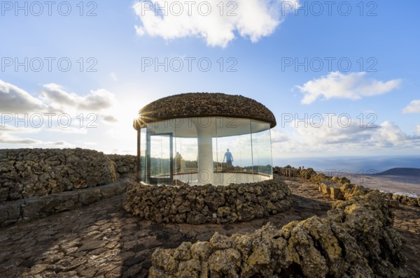 Staircase and viewing platform at the Mirador del Río viewpoint, in the evening light with sun