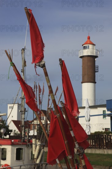 Timmendorf lighthouse on the island of Poel on the Baltic Sea, rigging and flags from a boat in the