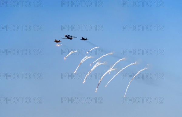 The Indian Air Force aerobatic team performs during an air show as part of the 93rd Air Force Day