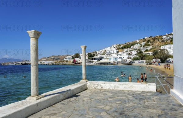 Mykonos, Cyclades, Greece - Tourists and locals like to bathe at the small town beach Paralia