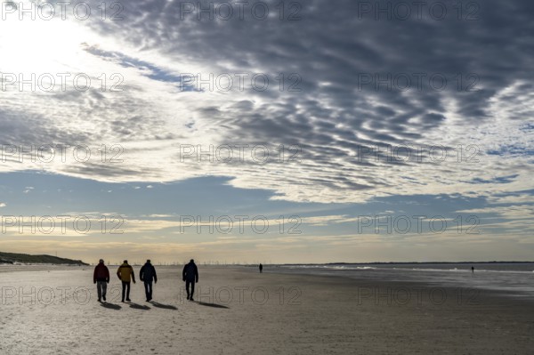 Walkers on the Wadden Sea near the East Frisian island of Spiekeroog, west of the North Sea island,