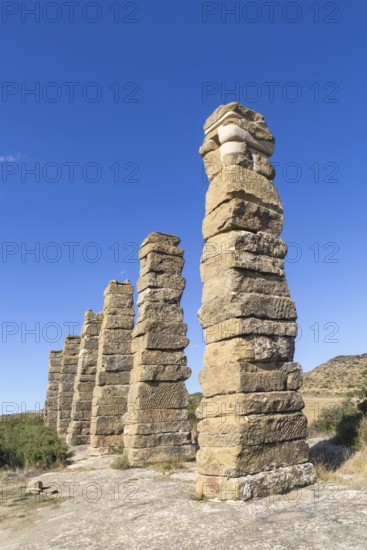 Stone columns of ancient aqueduct, Roman site of Los Banales, near Layana, Zaragoza province,