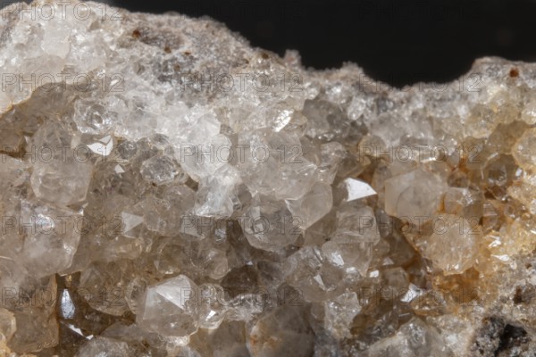 Vibrating quartz crystals mix with rock formations and capture light in a natural spring atmosphere