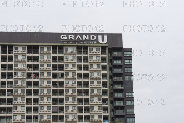 Exterior façade of a residential high-rise building of Condo U (a brand or series name of the Thai