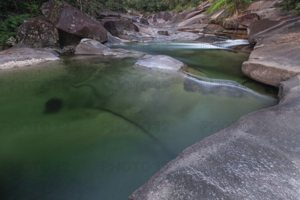 Turquoise blue water between rocks in the tropical rainforest of Babinda Boulders Queensland