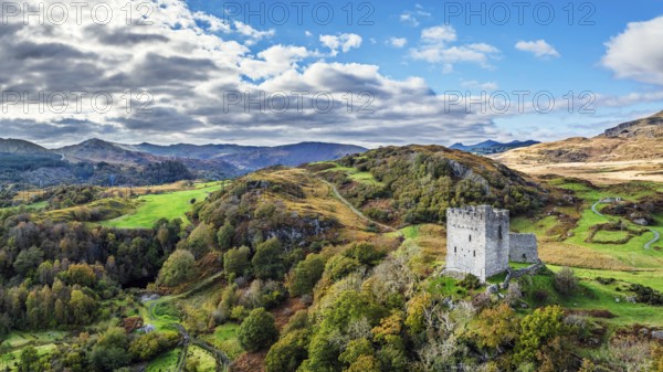 Autumn colours over Castell Dolwyddelan and Eryri Mountains from a drone, Snowdonia, Conwy County