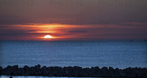 Sunset on the Baltic Sea with protective breakwaters, Darß, Ahrenshoop, Mecklenburg-Western