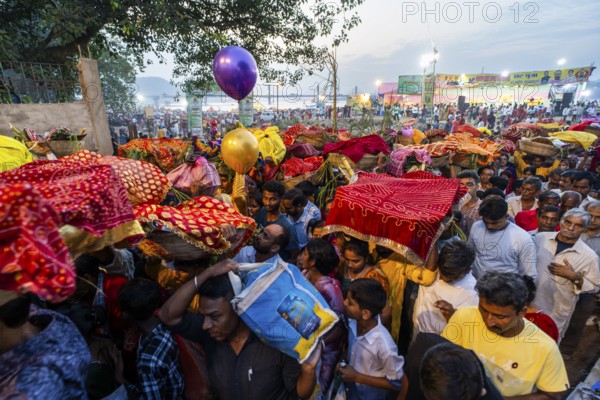 Hindu devotees gather on the banks of the Brahmaputra River to offer prayers to the Sun God on the