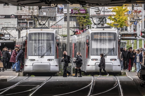 Pedestrians cross the tram tracks, at Düsseldorf-Bilk station, junction of S-Bahn, subway, tram,