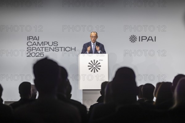 Federal Chancellor Friedrich Merz (CDU) . Portrait at the lectern with free text space.