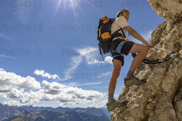 Mountaineer climbs on Ferrata Furcela de Saslonch, Langkofelscharte via ferrata, Dolomites,