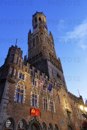 Illuminated Belfry in the historic city centre of Bruges in the evening light, Belfort and City