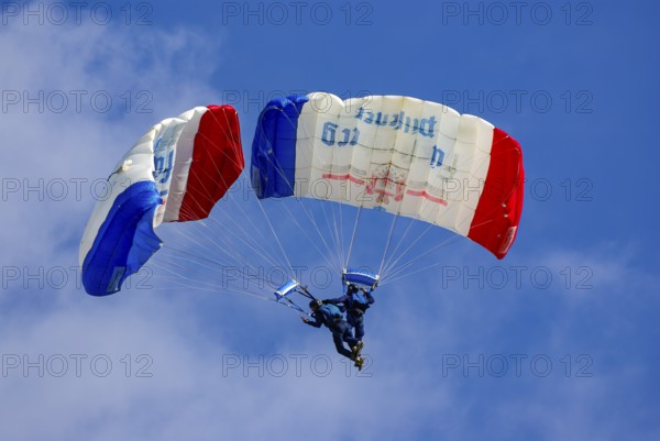 Two parachutists during an aerial acrobatic performance as part of an air show at the Rossfeld in