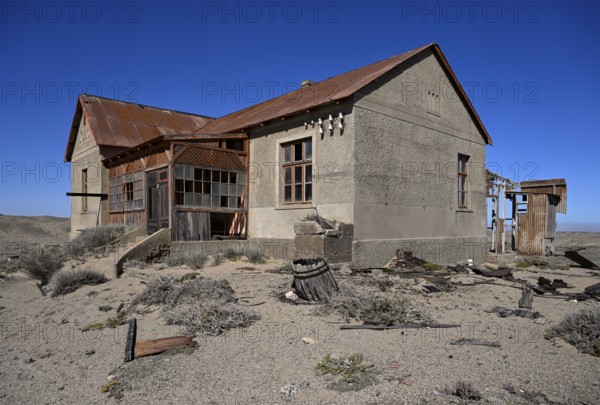 Dilapidated building in the desert sand, Pomona, restricted diamond area, near Lüderitz, Karas
