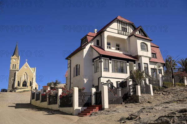 Colonial house facade in the Kirchstraße, in the background the rock church, Lüderitz, Karas