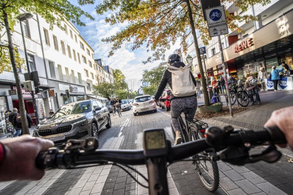 Cycling in the city, city centre road, cycle lane, two-wheeled traffic has priority, 30 km/h zone,