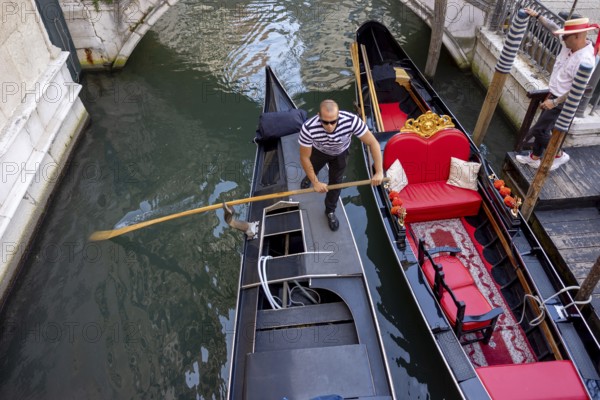 Venice, Italy - 3 September 2025: Gondolier on a gondola in Venice during the 82nd Venice