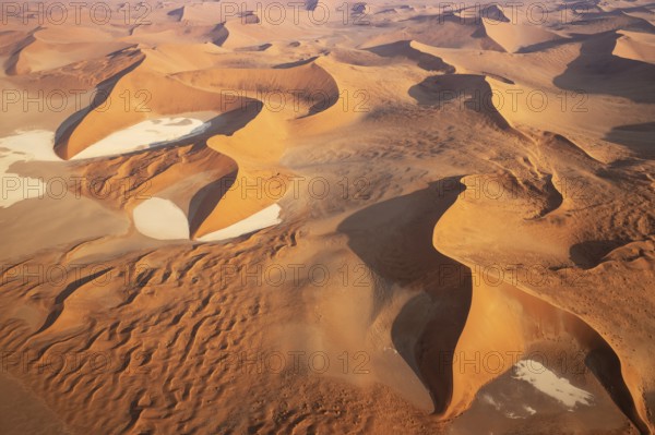 Sand dunes and dry pans in the Namib Desert. In the evening. Aerial view. Namib-Naukluft Park,