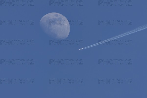 Boeing 737 jet passenger aircraft of Norweign Air with a vapour trial or contrail behind flying in